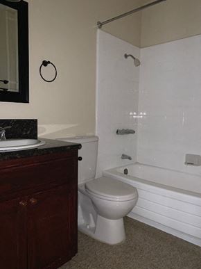 North Hollywood apartment for rent - A white toilet sits next to a white bathtub in a bathroom.