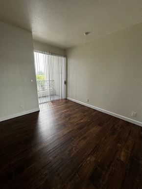 Los Angeles apartment for rent - A room with wooden floors and a sliding glass door.