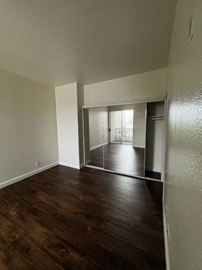 Los Angeles apartment for rent - A room with wooden floors and a sliding glass door.