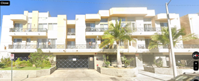 Los Angeles apartment for rent - A white apartment building with a black gate in front.