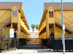 North Hills apartment for rent - A yellow building with a black gate in front.