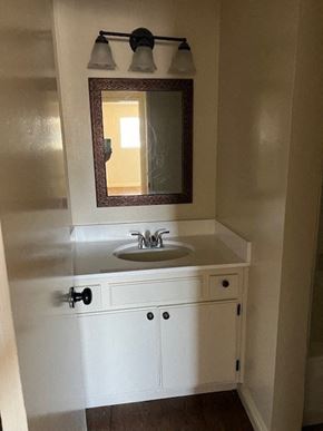 Canoga Park apartment for rent - A bathroom with a sink and a mirror.