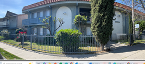 Canoga Park apartment for rent - A white house with a red roof and a black fence.