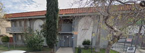 Canoga Park apartment for rent - A building with a red tile roof and a balcony.