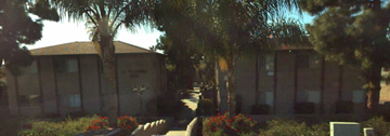 Vista apartment for rent - A building with a lawn in front of it.