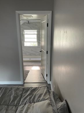 San Luis Obispo house for rent - A bedroom with a bed and a door leading to a bathroom.