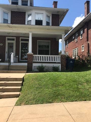 West Lawn house for rent - A red brick house with a white porch.