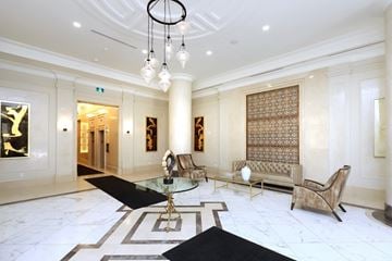 Mississauga apartment for rent - A living room with a glass table and a sofa.