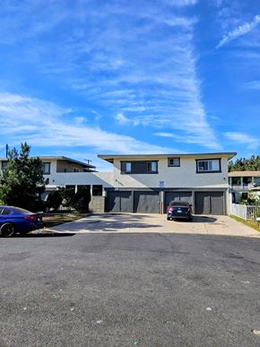 Downey apartment for rent - A modern two-story building with a parking lot in front.