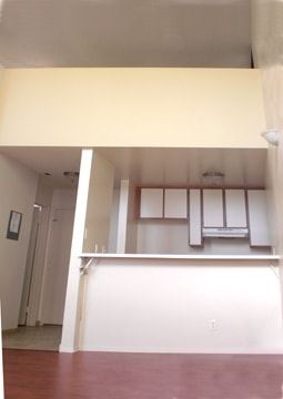 Los Angeles apartment for rent - A room with a white wall and a brown floor.