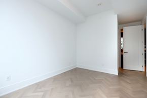 Toronto apartment for rent - A room with a white wall and a wooden floor.