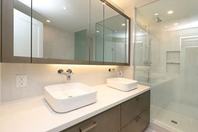 Toronto apartment for rent - A modern bathroom with a white sink and a large mirror.