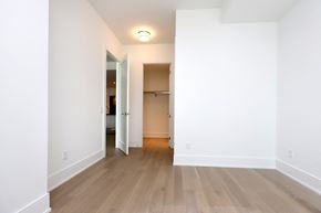 Toronto apartment for rent - A room with a white wall and a wooden floor.