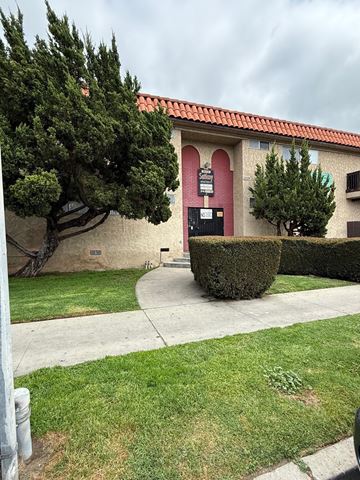 Canoga Park apartment for rent - A building with a red roof and a sign on it.