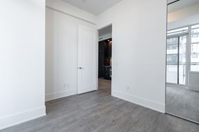 Toronto apartment for rent - A room with a white door and a grey floor.