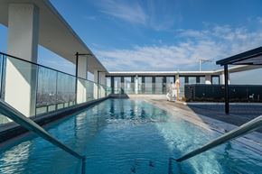 Toronto apartment for rent - A long rectangular pool with a metal railing on the side.