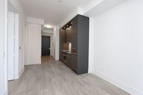 Toronto apartment for rent - A long hallway with a kitchen area on the right.