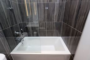 Toronto apartment for rent - A white sink in a modern bathroom with a glass shower door.
