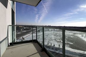 Mississauga apartment for rent - A balcony with a view of a snowy landscape and a clear blue sky.