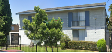 Van Nuys apartment for rent - A white house with blue shutters and a black fence.