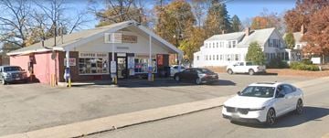 Leominster apartment for rent - A white car is parked in front of a coffee shop.