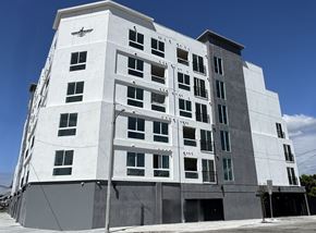 Inglewood apartment for rent - A white building with black windows and a black awning.