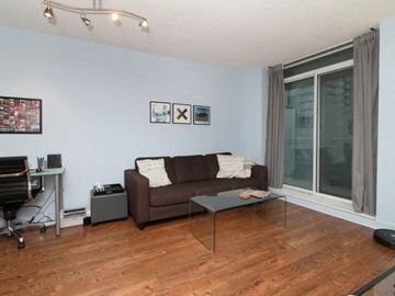 Toronto apartment for rent - A living room with a brown couch and a coffee table.