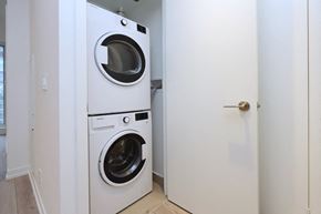 Toronto apartment for rent - A white washing machine and dryer in a small room.