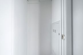 Toronto apartment for rent - A white door with a handle and a vent on the side.