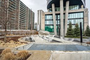 Toronto apartment for rent - A modern building with a pool in front.