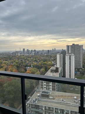 Toronto apartment for rent - A cityscape with buildings and trees in the foreground.