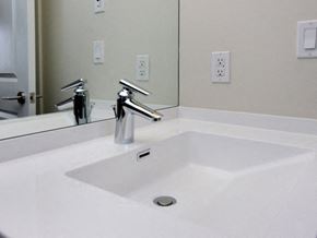 Etobicoke apartment for rent - A white sink with a chrome faucet is in front of a mirror.