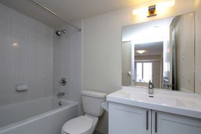 Etobicoke apartment for rent - A white bathroom with a toilet, sink, and tub.