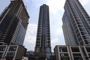 Etobicoke apartment for rent - Three tall buildings are seen from a low angle.