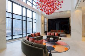 Etobicoke apartment for rent - A modern living room with a large window and a chandelier.