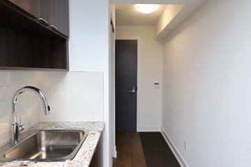 Etobicoke apartment for rent - A kitchen with a sink and a door.