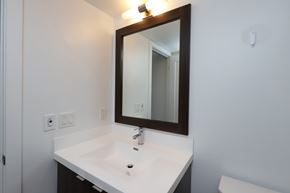 Etobicoke apartment for rent - A white sink under a mirror in a bathroom.
