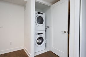 Etobicoke apartment for rent - A white washer and dryer are stacked in a small space.