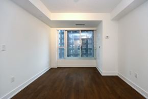 Toronto apartment for rent - A room with a window and wooden floors.