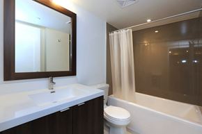 Toronto apartment for rent - A white sink is on a counter under a mirror.