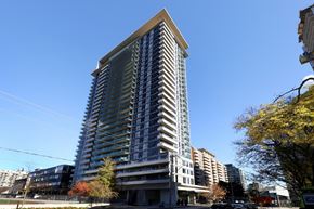 Toronto apartment for rent - A tall building with a blue sky in the background.