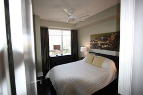 Toronto apartment for rent - A bedroom with a large bed and a ceiling fan.
