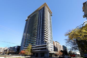 Toronto apartment for rent - A tall building with a blue sky in the background.
