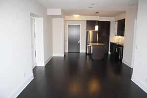 Toronto apartment for rent - A kitchen with a refrigerator, stove, and cabinets.