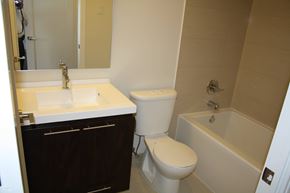 Toronto apartment for rent - A white toilet sits next to a sink in a bathroom.
