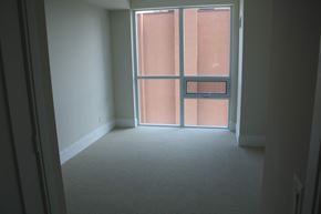 Toronto apartment for rent - A room with a carpeted floor and a sliding glass door.