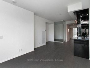Toronto apartment for rent - A spacious room with a kitchen area in the background.