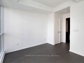 Toronto apartment for rent - A spacious room with white walls and a doorway leading to another room.