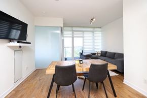 Toronto apartment for rent - A dining room with a wooden table and chairs.