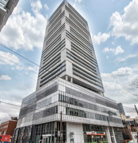Toronto apartment for rent - A tall building with a curved top and a striped facade.